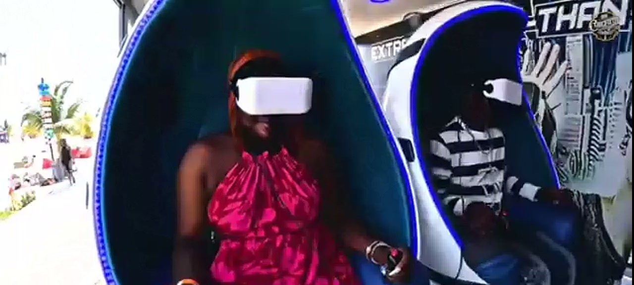 Guests seated in immersive VR pods at a beachfront event