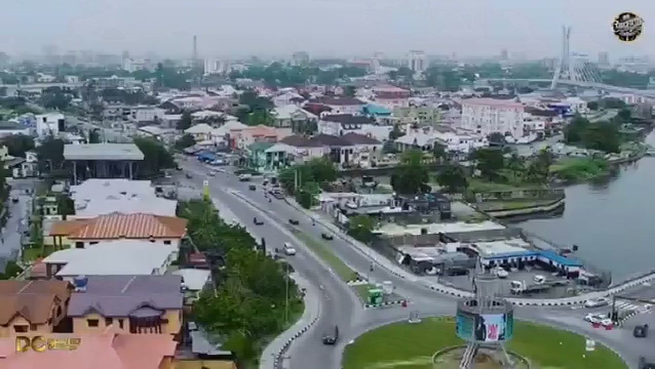 Aerial view of Lagos rooftops, road and lagoon at dusk