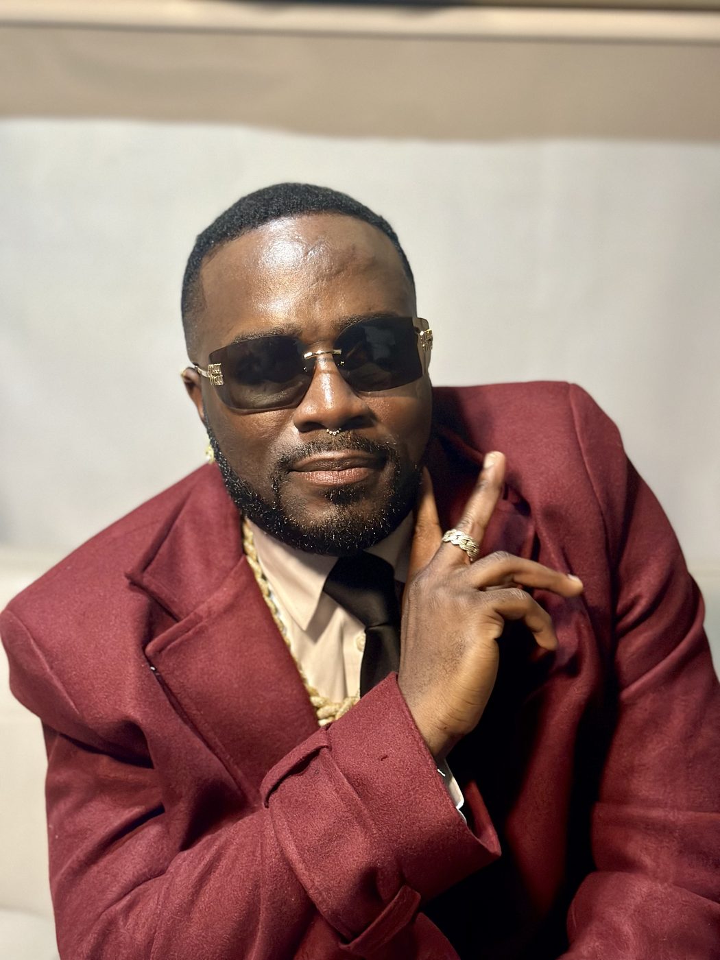 Don Crucifixto in a crimson suit, close editorial frame