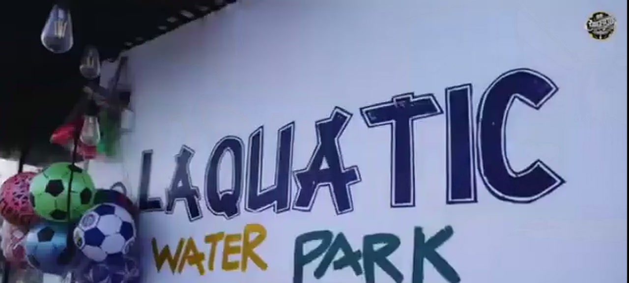 Hand-painted water park signage at a Landmark Beach event day
