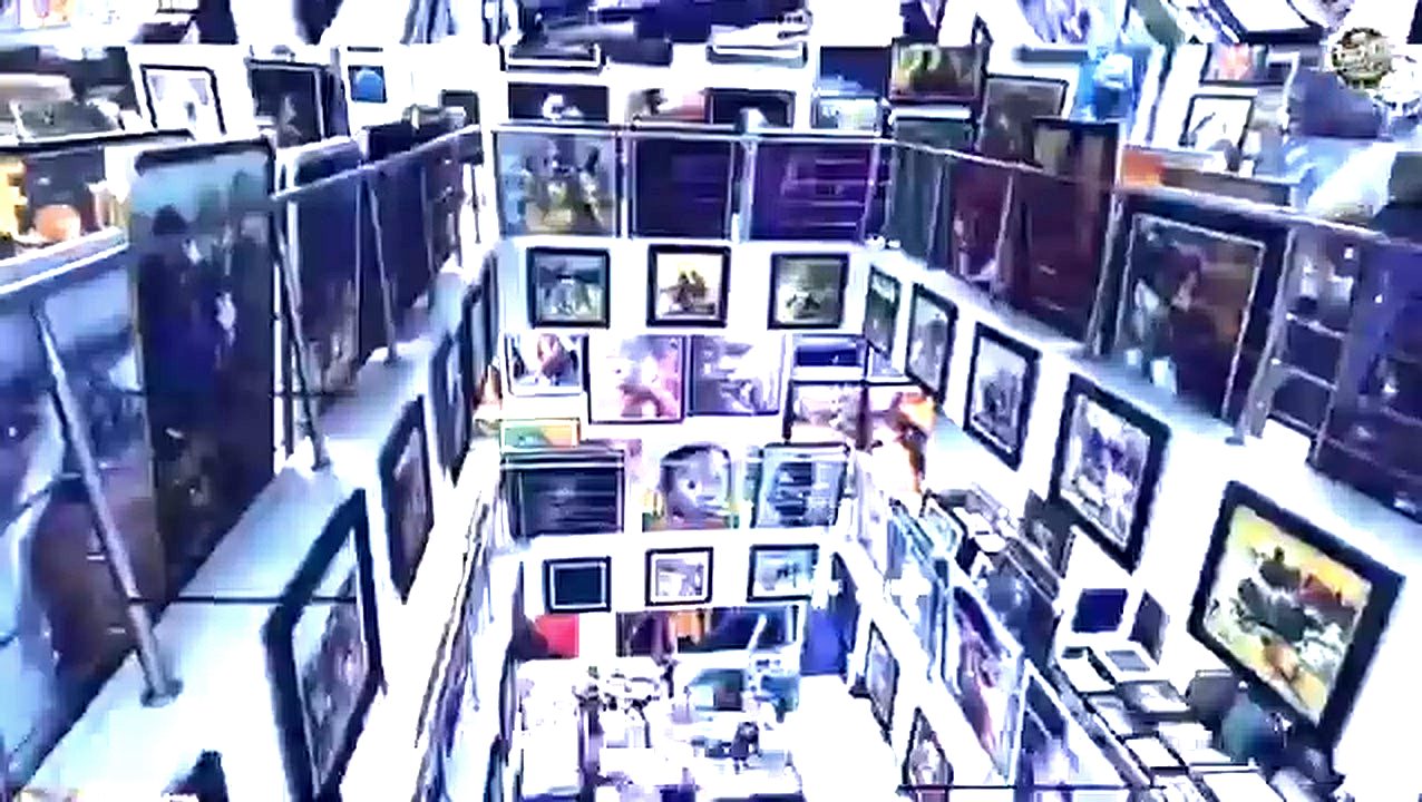 A densely hung Lagos art gallery, floor to ceiling with framed work