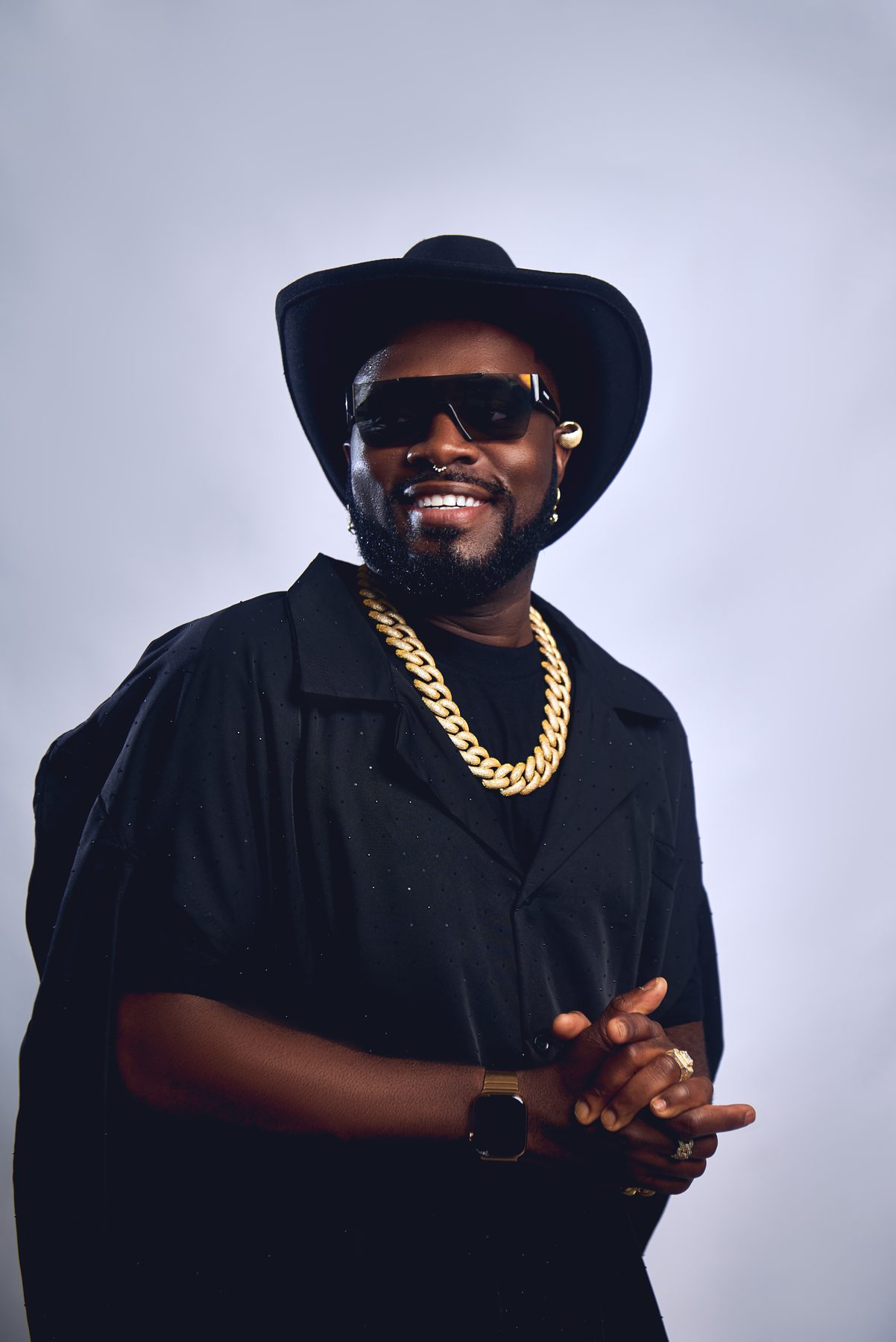 Don Crucifixto in black tailoring and a wide-brimmed hat